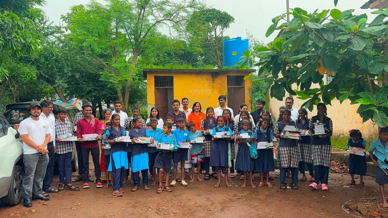 Children and volunteers with educational materials during a Rudra Foundation education outreach activity