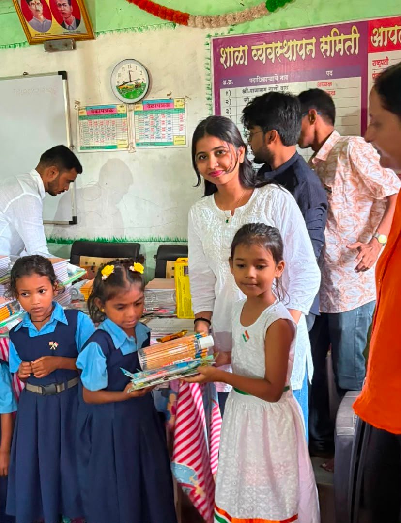 Children receiving educational materials from Rudra Foundation volunteers