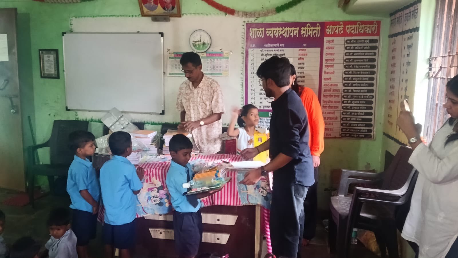 Volunteers distributing books and educational materials to children