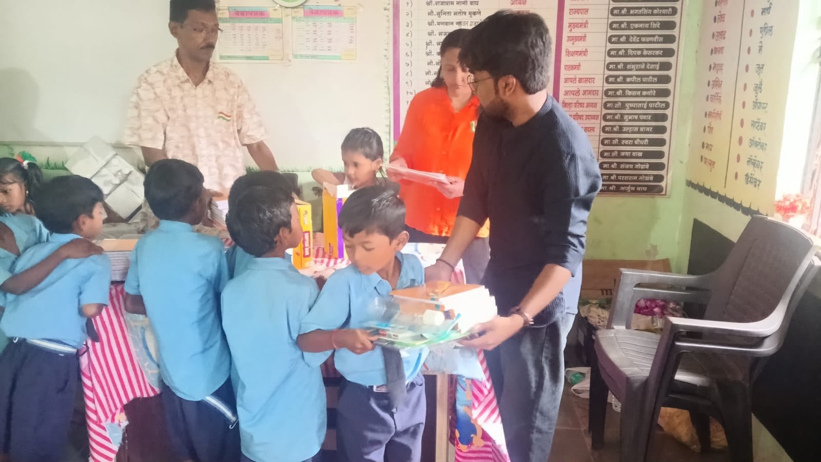 Children receiving educational materials during a distribution drive
