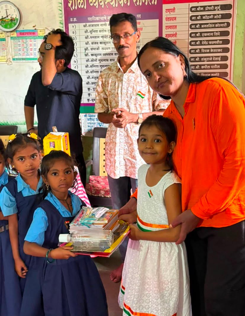 Children receiving educational materials through Rudra Foundation child support work