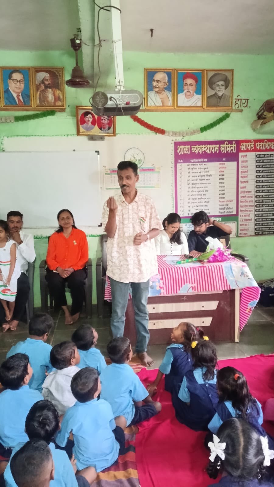 A community member addressing children during a volunteer activity